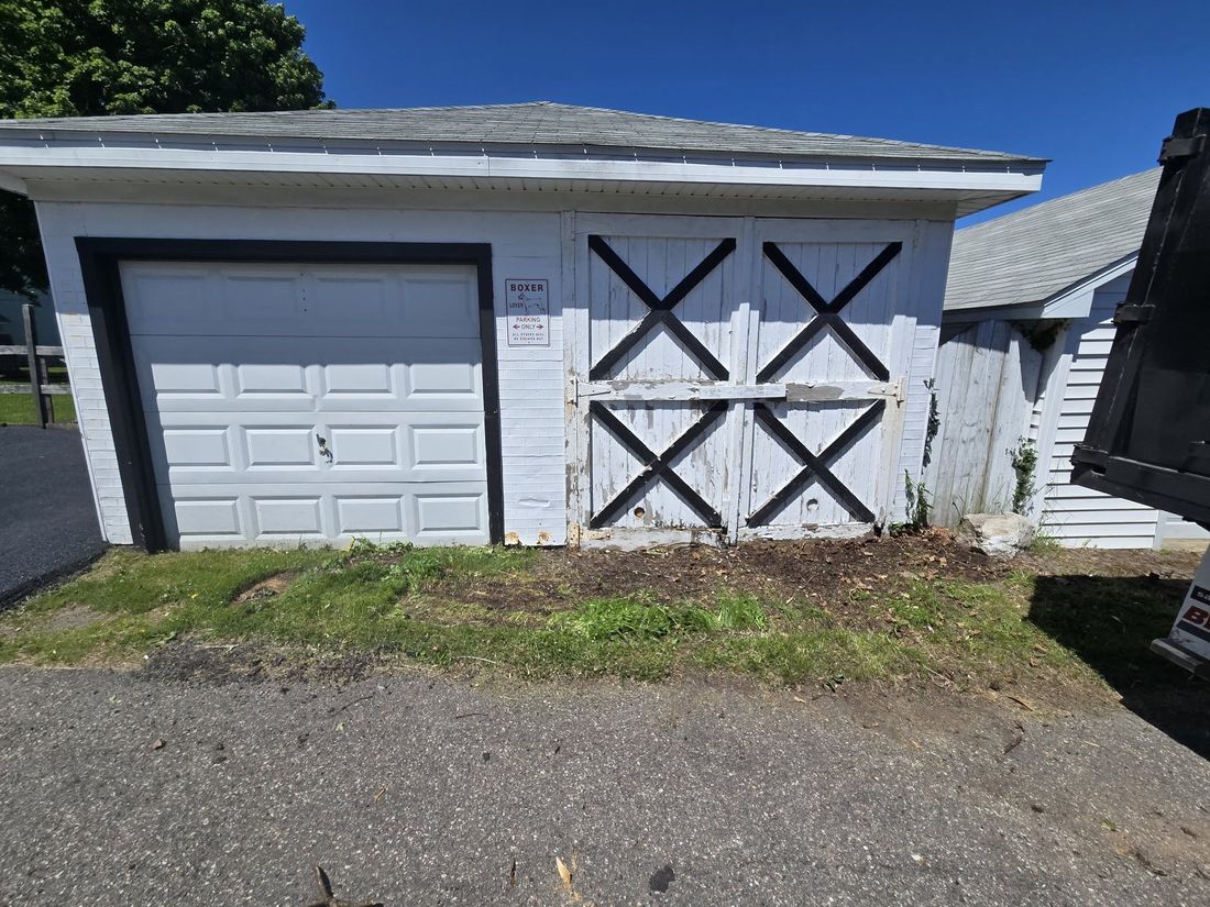 Garage exterior cleared of debris after cleanup